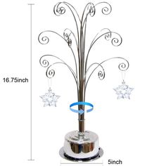 a metal christmas tree with star decorations on it's base and blue ribbon hanging from the top