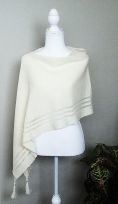 This off white merino wool poncho is very elegant and is suited to complement different outfits, it is also suitable for weddings or other formal events in your life. It's the simplest way to add some colour and freshness to your wardrobe and stylize your everyday garments. A great gift for a loved one.    Knitted 100% merino wool ponchos. The poncho is available in one size. ❤️ Several wearing variants: as poncho, scarf, headgear, beach tunic, scarf, cape, vest and etc. ❤️ Handmade with love for you Gift wrapping available.  Hand washed in lukewarm water with delicate detergent, better flat to dry.  Please note that the colours might be a little different on your computer screen. Elegant Beige Poncho For Fall, Elegant Oversized Wool Poncho, Elegant One-size Cashmere Poncho, Elegant Winter Cape Poncho, Elegant Oversized Poncho Cape, Elegant Oversized Cape Poncho, White Poncho For Layering, Elegant Beige Cape Poncho, Elegant Beige Poncho