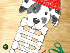 a paper cut out of a dog wearing a fireman's hat and holding a bone