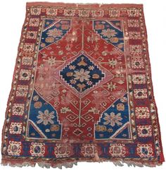 an old rug with many different colors and patterns on the ground, including red, blue,