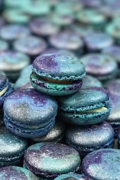 some blue and purple macaroons stacked on top of each other