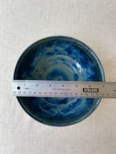 a measuring tape is in front of a blue bowl