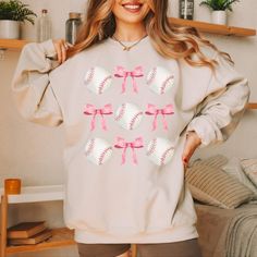 🎀 Step into the world of sporty style and feminine charm with our Baseballs and Bows Collage Sweatshirt! This cozy piece is perfect for expressing your love for the game while adding a dash of chic flair to your wardrobe. Crafted from ultra-soft, premium fabric, this bow sweatshirt promises warmth and comfort whether you're cheering at the ballpark or hanging out with friends. Its relaxed fit makes it perfect for layering on cooler days or enjoying a laid-back day at home. The highlight of this Bow Sweatshirt, Collage Design, Hanging Out With Friends, Sporty Chic, Cute Bows, Out With Friends, Sporty Style, Custom Clothes, Hanging Out