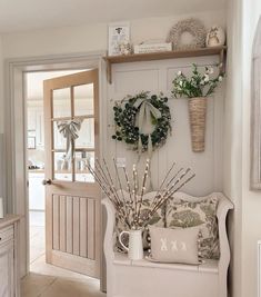 a living room filled with lots of furniture and decor on top of a wooden shelf