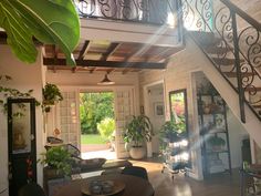 the inside of a house with stairs and plants