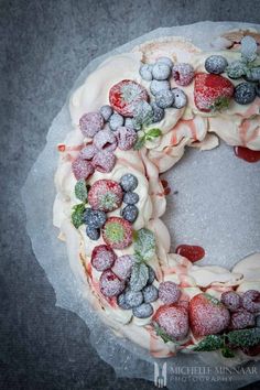 a cake with frosting and berries on it