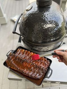 a person is using a bbq tongs to cook ribs on the stove top