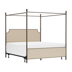 the canopy bed is made with metal posts and linens, which are also beige