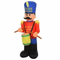 a wooden toy soldier holding a drum