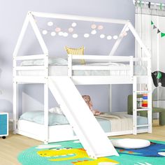 a white bunk bed with a slide in the middle