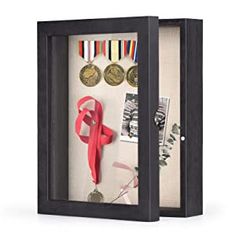 a display case with medals and ribbons in it's shadow box on a white background