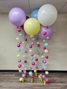 several balloons are floating in the air with confetti and streamers attached to them