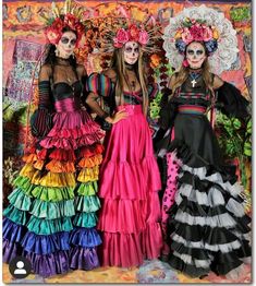 three women in colorful dresses standing next to each other