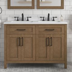 a bathroom vanity with two mirrors above it and white tiles on the wall behind it