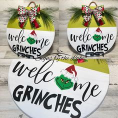 two welcome gringies signs hanging on the side of a wooden wall next to pine branches