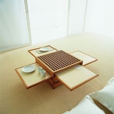 a table that has some plates on top of it in the middle of a room