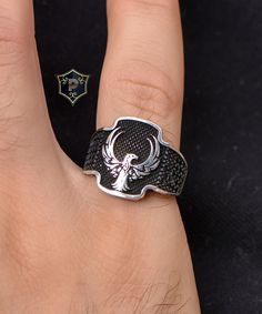 "Phoenix Turkish Silver Ring, Men's Handmade Silver Ring, Micro Black Onyx Stone Ring, 925 Sterling Silver Ring, Phoenix Mens Ring ✦ Details ✦ * Material: 925 Sterling Silver * Gemstone: Micro Onyx * Weight: 7.00 grams * Sides oxidized, decorated with and Micro Onyx stones. * Stamp: 925 * Available sizes; 5 US to 16 US. Contact me if you need any other size! ✦ Shipping ✦ * Processing time: 1-3 business days. * This item ships from my Turkish workshop in Istanbul. * Add your phone number in address box for a smoother delivery. That makes courier personnel's job easier.  ✦ Packaging ✦ * Comes with a luxury gift box and a jewellery cleaning cloth. ✦ Returns, Exchanges ✦ * Return option available for 30 days after the delivery. * The product has to be in the same shape, type, and material. * P Black Skull Ring With Open Design As Gift, Black Open Skull Ring As A Gift, Adjustable Black Symbolic Signet Ring, Adjustable Engraved Black Ring, Black Symbolic Adjustable Rings, Adjustable Black Symbolic Rings, Symbolic Black Skull Ring, Symbolic Black Sterling Silver Engraved Ring, Symbolic Black Engraved Sterling Silver Ring