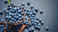 blueberries in a wooden bowl and spoons on a table