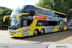 a double decker bus is parked on the side of the road with trees in the background