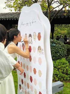 two women are writing on a large poster