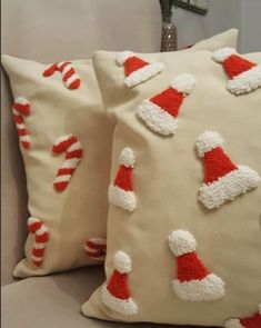 two decorative pillows with santa hats on them