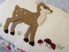 a close up of a pillow with a deer on it