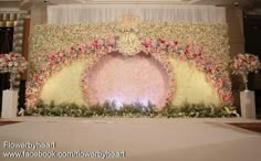 the stage is decorated with flowers and greenery for an elegant wedding or special event