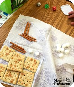 crackers and marshmallows are laid out on a table next to a board game