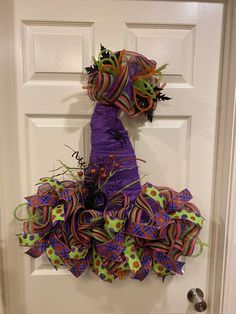 a purple and green wreath on the front door