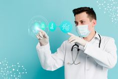 a male doctor in a white coat and face mask is pointing at icons