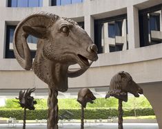 several sculptures of animals in front of a building