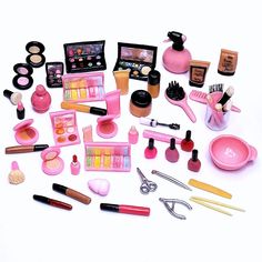 a collection of makeup and beauty products on a white surface with scissors, hairbrushes, eyeliners, etc