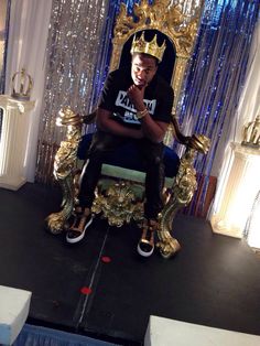 a man sitting on top of a golden throne