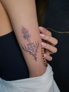 a woman with a flower tattoo on her arm