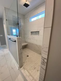 a bathroom with a walk in shower sitting next to a sink and mirror on the wall