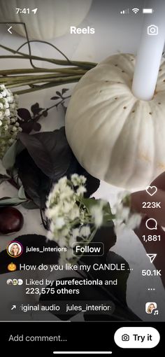 an image of a candle surrounded by flowers and other things on the phone screenshot