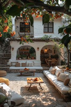 an outdoor living area with couches and tables