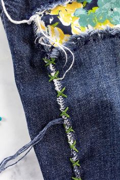 an upturned pair of jeans with green stitchs