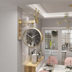 a clock hanging from the side of a wall above a dining room table with pink chairs