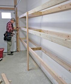 a man working on some shelves in a garage