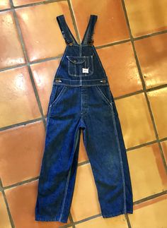 "Here is a great pair of vintage child size overalls in great condition. There are a dark cone denim with white stitching and have the \"SR Strong Reliable\" brass buttons and also label that reads \"Shrunk under the Sanforized Process Reg US Pat\". Found in an estate with flannel shirt pictured....for sale separately. Measurements taken lying flat across: Waist 12.5\", Hips 16.5\", Inseam 21.5\", Waist to hem 30\"" Vintage Denim Blue Overalls, Vintage Dark Wash Overalls, Vintage Dark Wash Bib Front Overalls, Vintage Denim Blue Bib Front Jeans, Brass Buttons, Cocktail Party Dress, Novelty Print, Denim Overalls, Lovely Dresses