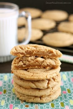 a stack of cookies sitting on top of a table next to a glass of milk