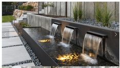 an outdoor water feature with rocks and plants