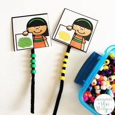 two children's pencils with pictures on them and beads in front of them