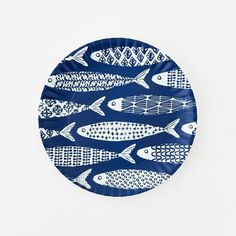 a blue and white plate with fish on it