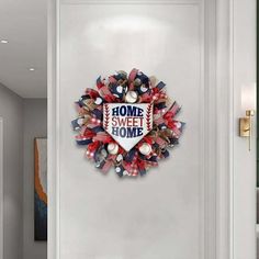 a door with a wreath on it and the words home sweet home written in red white and blue