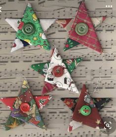 christmas ornaments are hanging on sheet music