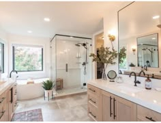 a large bathroom with two sinks and a bathtub