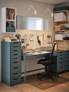 a home office area with desk, filing cabinets and shelves on the wall above it