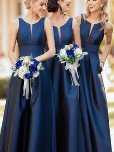 three bridesmaids in blue dresses standing together